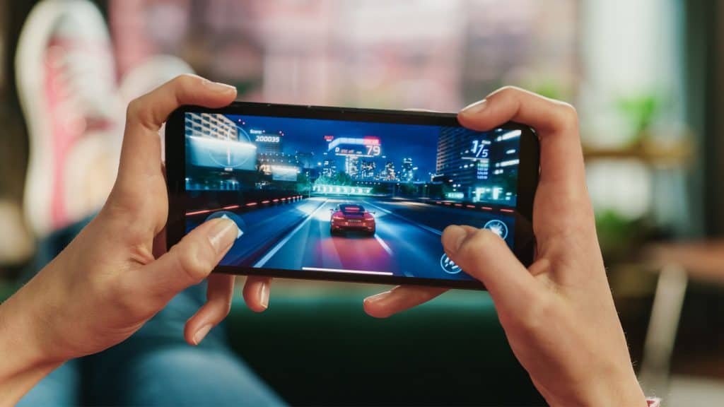 Person playing racing game on mobile