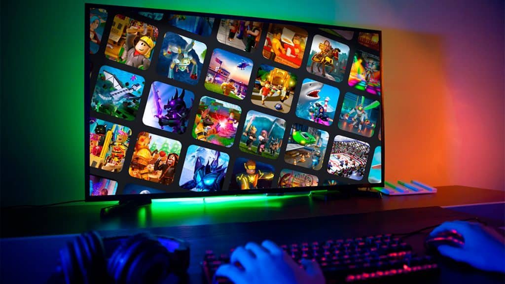 Person playing on a gamer computer with Epic Games Games icons on the screen
