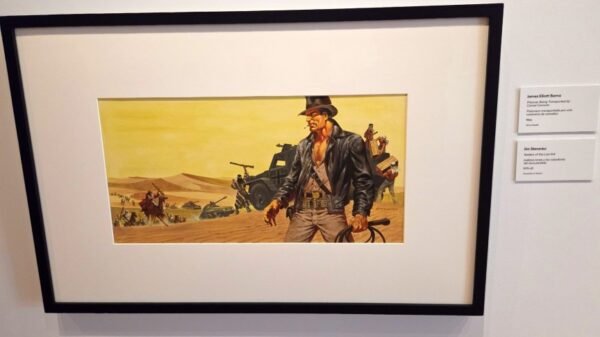 In a frame on a museum wall is Jim Steranko's illustrated concept art for Indiana Jones and the Raiders of the Lost Ark.