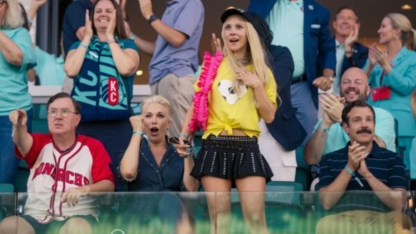 The cast of Ted Lasso season 4 applauding from the stands.